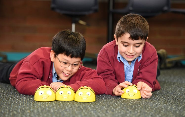 Two boys using the Beebots