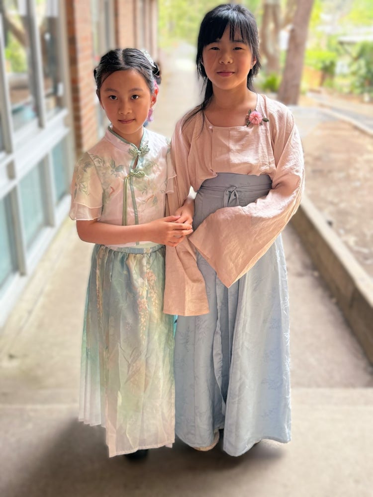 Two girls in a traditional and cultural dress to celebrate multicultral day