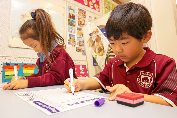 Two students working at their desk