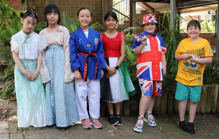 A group of students wearing traditional and cultural outfits